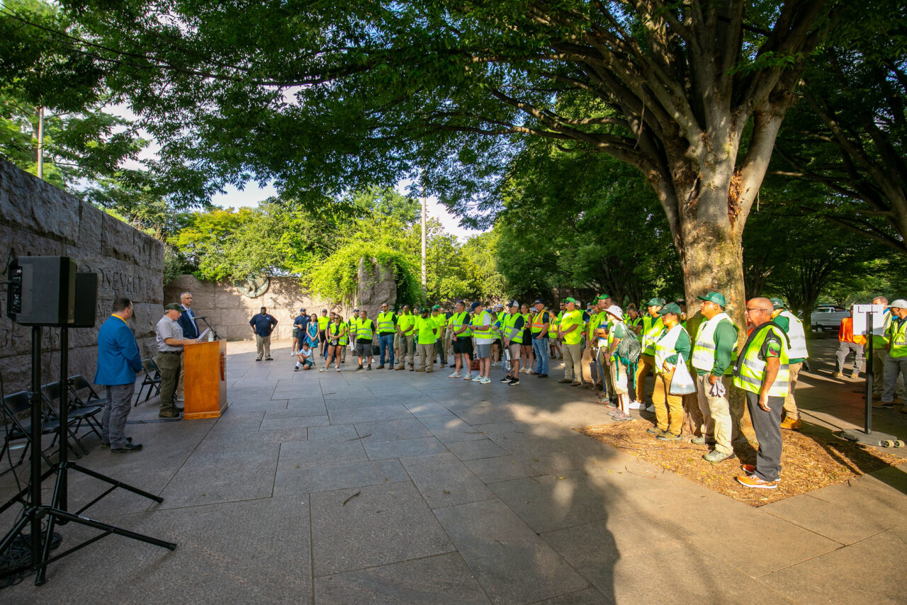 group of volunteers listening to remarks from the National Parks Service
